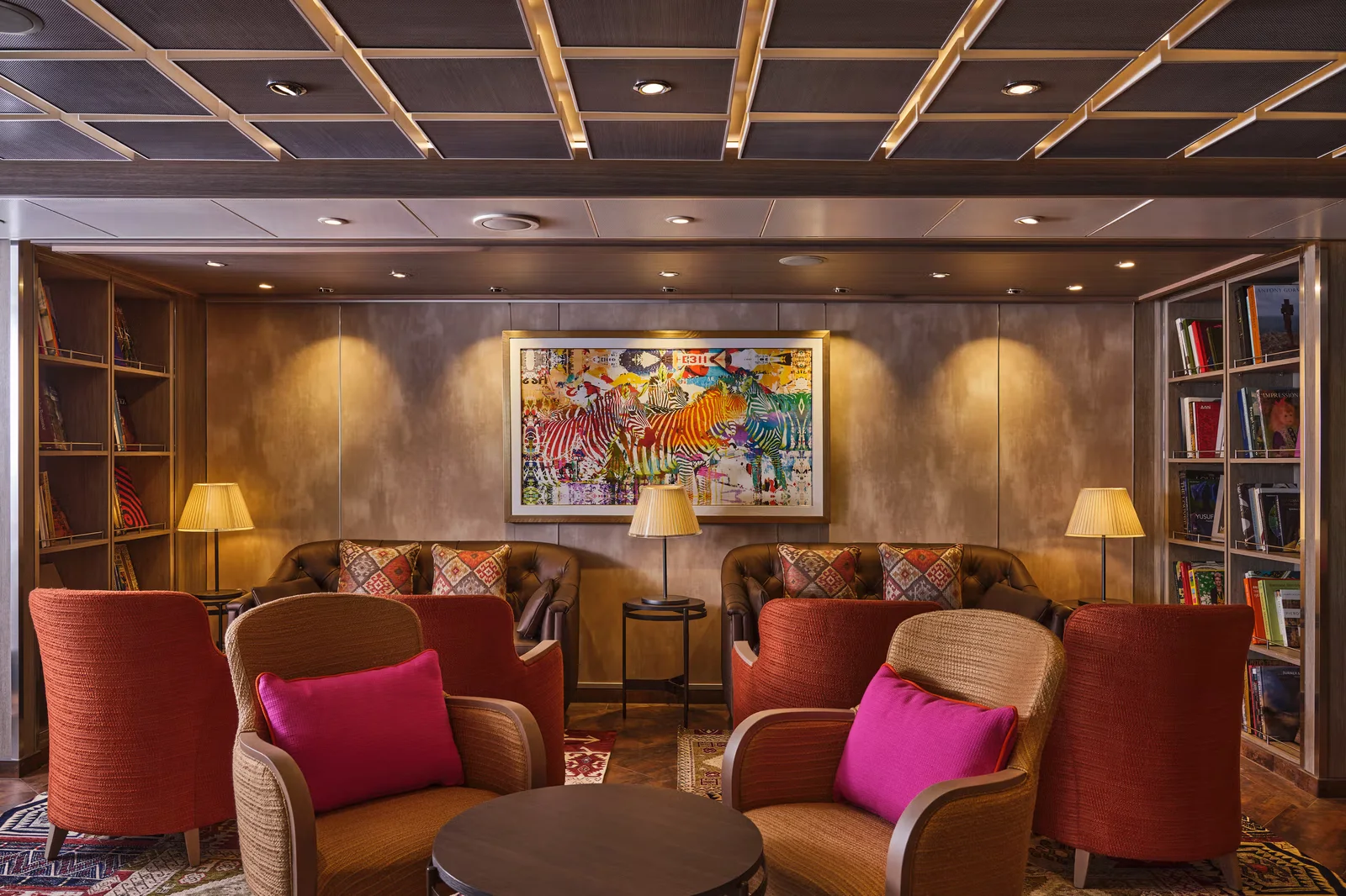 Silversea ship lounge and library with warm lighting, curated bookshelves, and colorful original artwork